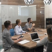 Businesspeople gathered around conference table