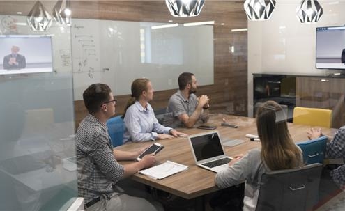 Businesspeople gathered around conference table