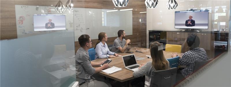 Businesspeople gathered around conference table